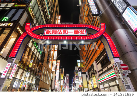 Night view of the Kabukicho Ichiban-gai gate, an entertainment district in Shinjuku, Tokyo, Japan. The buildings are filled with all kinds of colorful signboards. Night view of the Kabukicho Ichiban-gai gate, an entertainment district in Shinjuku, Tokyo, Japan. The buildings are filled with all kinds of colorful signboards. 141551689