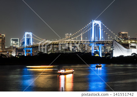 Night view of the Rainbow Bridge in Minato, Tokyo, Japan. It's a suspension bridge crossing northern Tokyo Bay between Shibaura Pier and the Odaiba waterfront development. Night view of the Rainbow Bridge in Minato, Tokyo, Japan. It's a suspension bridge crossing northern Tokyo Bay between Shibaura Pier and the Odaiba waterfront development. 141551742