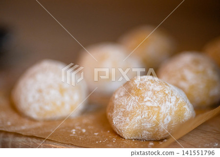 Baked sweet pastry balls in powdered sugar close up Baked sweet pastry balls in powdered sugar close up 141551796