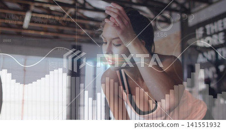 Pausing woman in light athletic top leaning and pressing forehead at gym studio, with digital HUD Pausing woman in light athletic top leaning and pressing forehead at gym studio, with digital HUD 141551932