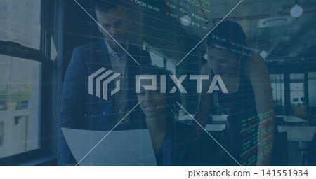 Reviewing team with manager in blazer examining report at office desk, with stock charts overlay Reviewing team with manager in blazer examining report at office desk, with stock charts overlay 141551934