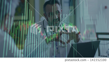 Explaining doctor in lab coat stethoscope gesturing at clinic desk with laptop and charts overlay Explaining doctor in lab coat stethoscope gesturing at clinic desk with laptop and charts overlay 141552100
