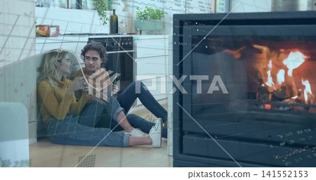 Sitting two women wearing sweaters leaning close on wood kitchen floor, holding mug, graphs showing 141552153