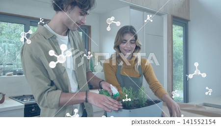 Planting couple potting herbs in home kitchen with planter, molecular overlays, khaki and mustard Planting couple potting herbs in home kitchen with planter, molecular overlays, khaki and mustard 141552154