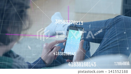 Tapping adult woman holding smartphone on sofa, wearing blue jeans and socks, showing data overlays Tapping adult woman holding smartphone on sofa, wearing blue jeans and socks, showing data overlays 141552188