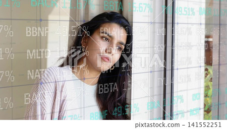 Gazing midadult woman in pale cardigan and small hoops near home glass door viewing stock overlay 141552251