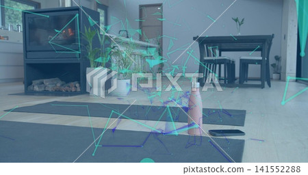 Placing two dark yoga mats in living room at home, showing pink bottle, phone and wireframe-overlay Placing two dark yoga mats in living room at home, showing pink bottle, phone and wireframe-overlay 141552288