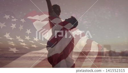 Silhouetted man lifting partner on beach at sunset, wearing casual beachwear, American flag overlay Silhouetted man lifting partner on beach at sunset, wearing casual beachwear, American flag overlay 141552315