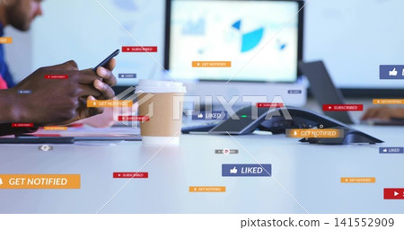 Focusing paper coffee cup with lid at office table, man in long sleeves using smartphone, badges Focusing paper coffee cup with lid at office table, man in long sleeves using smartphone, badges 141552909
