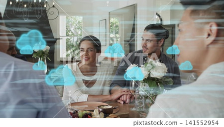 Holding hands couple in light keyhole-top and dark-shirt sitting at home with fruit-board, AR icons 141552954