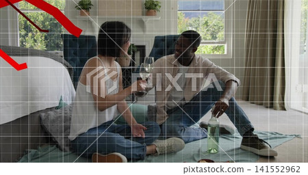 Sitting couple wearing casual clothes holding wine glasses on bedroom blanket, with green bottle Sitting couple wearing casual clothes holding wine glasses on bedroom blanket, with green bottle 141552962