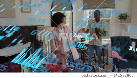 Packing couple in polo, pink shirt handing clothes in bedroom near open suitcase blue data overlay Packing couple in polo, pink shirt handing clothes in bedroom near open suitcase blue data overlay 141552963