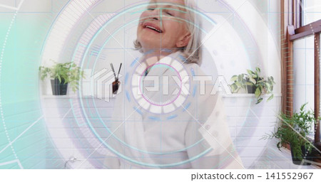 Smiling senior woman tilting head back in home bathroom, wearing robe with HUD and potted plants Smiling senior woman tilting head back in home bathroom, wearing robe with HUD and potted plants 141552967