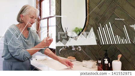 Holding bottle, senior woman in blue robe reaching for sink at home, charts overlay, copy space 141552971