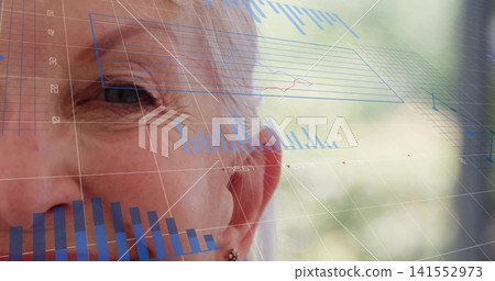 Gazing senior woman focusing beside window, with blue 3D gridlines, charts and stud earring 141552973