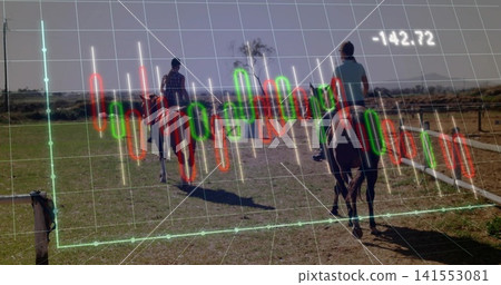 Riding two women on horses along fenced track at rural field, wearing helmets, candlestick overlay 141553081
