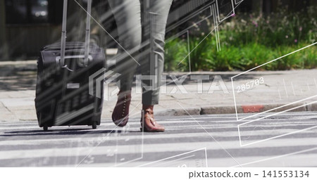 Walking woman pulling black suitcase on zebra crosswalk in pants, studded boots with white overlay Walking woman pulling black suitcase on zebra crosswalk in pants, studded boots with white overlay 141553134