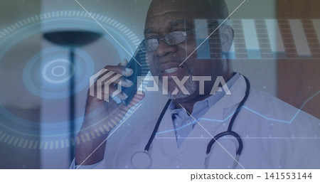 Speaking senior Black doctor holding phone and stethoscope, viewing HUD in clinic, wearing lab coat Speaking senior Black doctor holding phone and stethoscope, viewing HUD in clinic, wearing lab coat 141553144