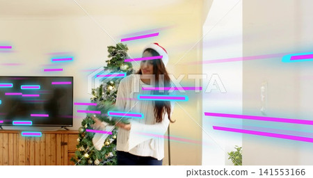 Holding Asian woman placing stocking near living room tree, wearing Santa hat and knit sweater Holding Asian woman placing stocking near living room tree, wearing Santa hat and knit sweater 141553166