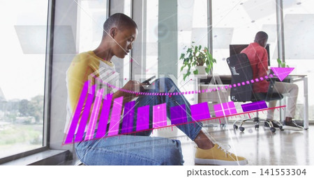 Checking phone, man on left windowsill wearing yellow top and jeans at office, with chart overlay Checking phone, man on left windowsill wearing yellow top and jeans at office, with chart overlay 141553304