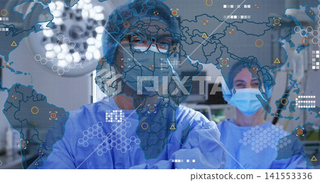 Standing surgical pair in blue gowns, masks and goggles in operating room viewing world map overlay Standing surgical pair in blue gowns, masks and goggles in operating room viewing world map overlay 141553336