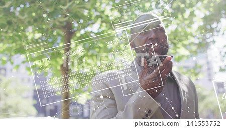 Speaking man wearing light jacket and shirt, holding phone showing AR overlays at park, copy space 141553752