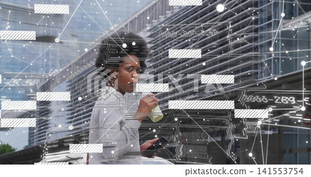 Sipping woman in gray sweater on sidewalk near metal wall holding phone bottle earbuds data overlay Sipping woman in gray sweater on sidewalk near metal wall holding phone bottle earbuds data overlay 141553754