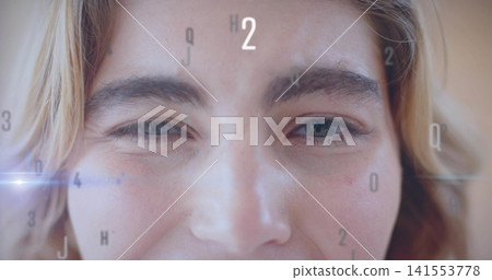 Squinting adult female face showing asymmetry with HUD letters and blue streak in studio closeup Squinting adult female face showing asymmetry with HUD letters and blue streak in studio closeup 141553778