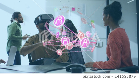 Interacting man wearing VR headset reaching toward pink holographic network in meeting room, laptop Interacting man wearing VR headset reaching toward pink holographic network in meeting room, laptop 141553879