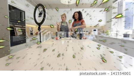 Preparing two women wearing striped aprons stirring and filming at kitchen island with ring light 141554001