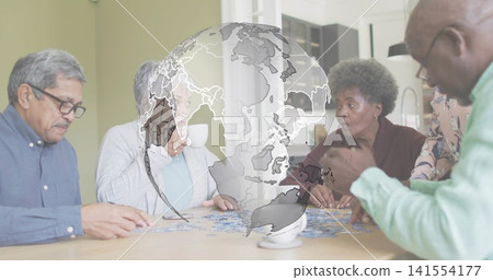 Working five seniors sorting puzzle pieces at kitchen dining table, with transparent globe overlay 141554177