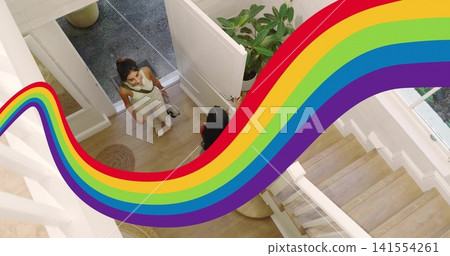 Chatting two women standing in foyer near open white door, wearing white sneakers, rainbow graphic Chatting two women standing in foyer near open white door, wearing white sneakers, rainbow graphic 141554261