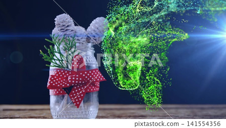 Showing glass jar with three cones sprig polka bow on wood table green-swirl lens-flare, copy space Showing glass jar with three cones sprig polka bow on wood table green-swirl lens-flare, copy space 141554356