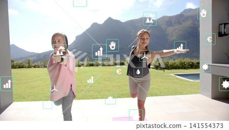 Balancing mother pink long-sleeve, teen dark-top holding yoga on terrace with pink mat and AR icons Balancing mother pink long-sleeve, teen dark-top holding yoga on terrace with pink mat and AR icons 141554373