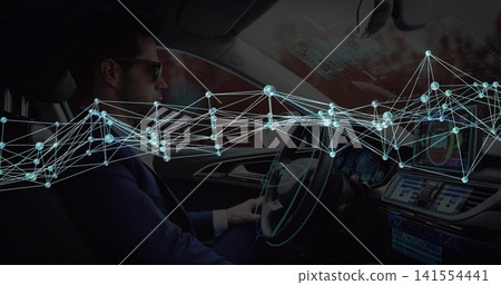 Sitting midadult driver in suit with shades holding wheel in cabin with touchscreen-AR, copy space Sitting midadult driver in suit with shades holding wheel in cabin with touchscreen-AR, copy space 141554441