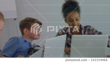 Typing teen in plaid shirt using silver laptop at classroom, with robotics chassis and data overlay Typing teen in plaid shirt using silver laptop at classroom, with robotics chassis and data overlay 141554468
