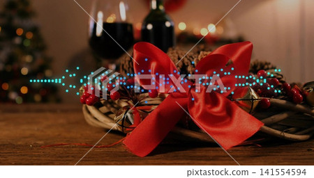 Featuring woven wreath topped by red bow on wooden table, with jingle bells, turquoise LEDs Featuring woven wreath topped by red bow on wooden table, with jingle bells, turquoise LEDs 141554594