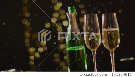 Displaying green champagne bottle and two flutes with rising bubbles on bar tabletop, bokeh Displaying green champagne bottle and two flutes with rising bubbles on bar tabletop, bokeh 141554615