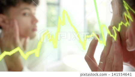 Touching man wearing stud earring, ring checking face in bathroom mirror, neon waveform, copy space 141554641
