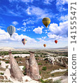Balloon flight, famous tourist attraction of Cappadocia. Air balloons and Fairy Chimney in Pasabag Valley, Anatolia, Turkey. Topic of vacation, travel, trip abroad on vacation, cruises and tours 141555471