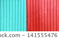 Wave Sheets fence of red and cyan colour. Horizontal background with galvanized iron sheets of different color. Colored corrugated metal roofing sheet 141555476