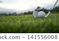 Golf clubs and balls on a green lawn in a beautiful golf course with morning sunshine. 141556008
