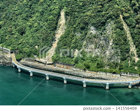 Aerial photograph capturing the elevated bridge and tunnel entrance around the Ishibe Marine Bridge on the Okuzure Coast in Shizuoka Prefecture. 141556409