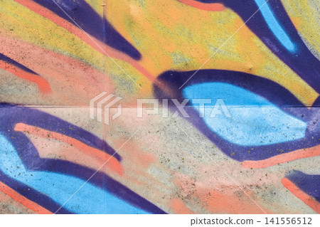 Bold, colorful graffiti mural sprayed on a concrete wall Bold, colorful graffiti mural sprayed on a concrete wall 141556512