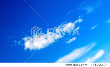 a lonely elongated white cloud against deep blue space a lonely elongated white cloud against deep blue space 141556623