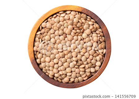 Top view of green lentils in a wooden bowl isolated on white background Top view of green lentils in a wooden bowl isolated on white background 141556709