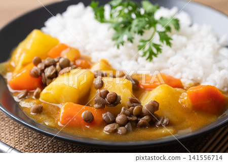 Japanese curry with lentil, carrot, potato and onion eating with cooked rice, Vegetarian food Japanese curry with lentil, carrot, potato and onion eating with cooked rice, Vegetarian food 141556714