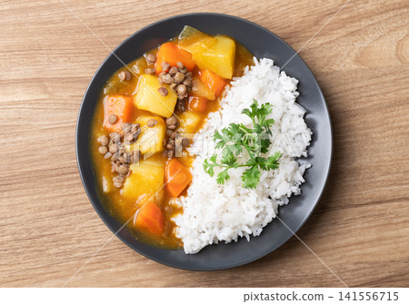 Japanese curry with lentil, carrot, potato and onion eating with cooked rice Japanese curry with lentil, carrot, potato and onion eating with cooked rice 141556715