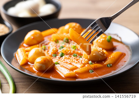 Tteokbokki with quail eggs ready to eat, Korean spicy rice cake traditional food Tteokbokki with quail eggs ready to eat, Korean spicy rice cake traditional food 141556719