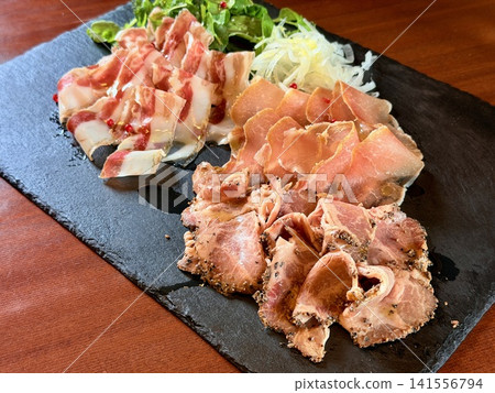 A platter of cured ham and gastronomy tourism, offering a taste of the natural bounty of Obihiro, Tokachi, Hokkaido, Japan. A platter of cured ham and gastronomy tourism, offering a taste of the natural bounty of Obihiro, Tokachi, Hokkaido, Japan. 141556794
